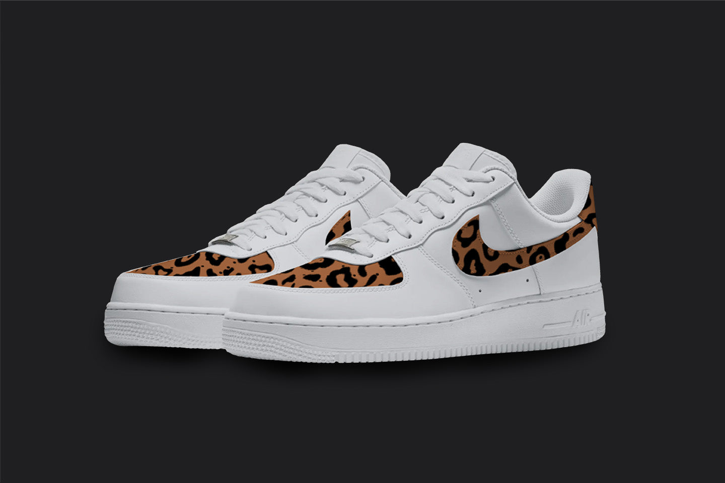 The image is of a Custom Nike Air force 1 sneaker pair on a blank black background. The white custom sneakers have a Cheetah print in the front and on the nike logos. 