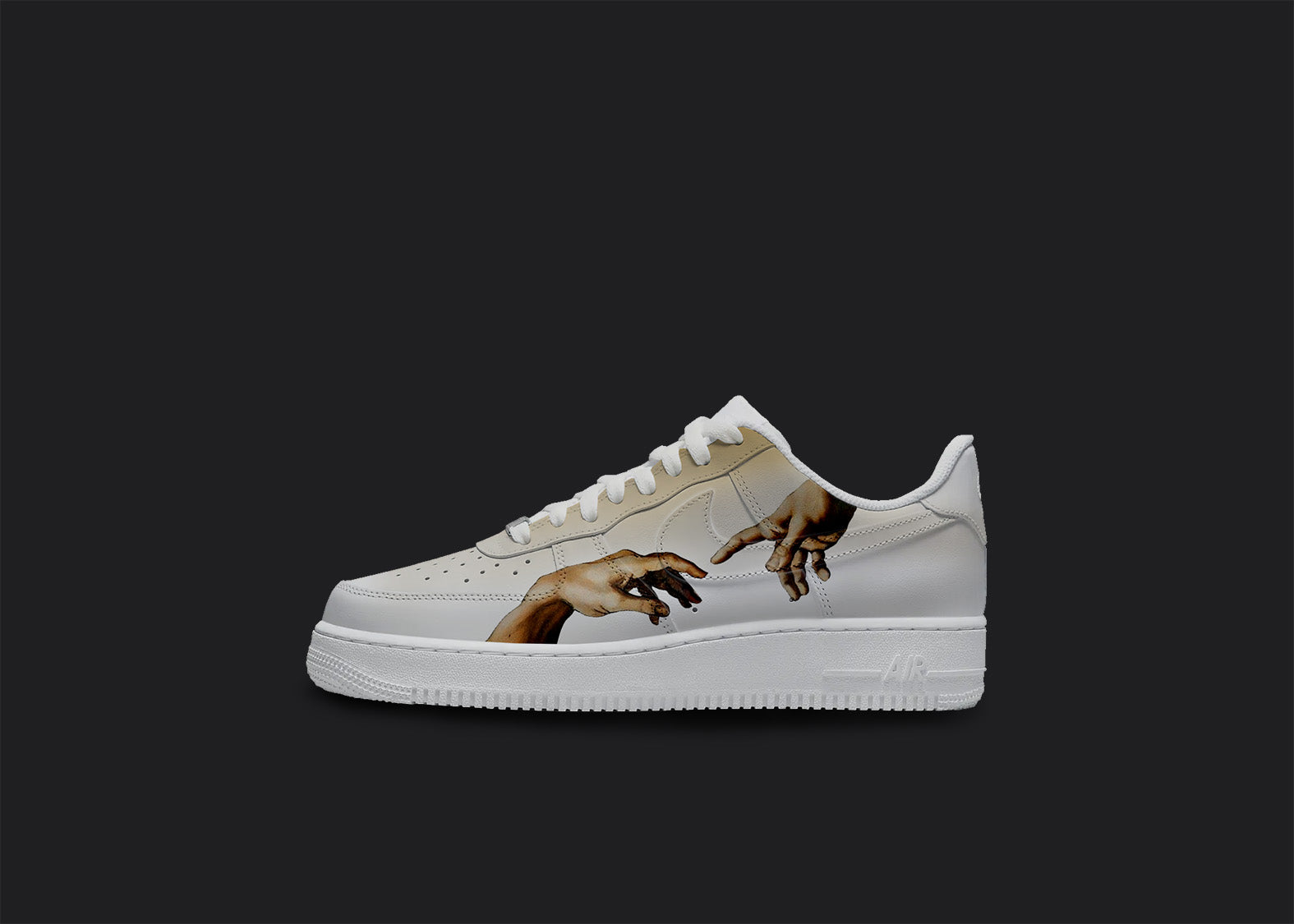 The image is of a Custom Nike Air force 1 sneaker on a blank black background. The white custom sneaker has a creation of adams hands design on the outside of the sneaker.