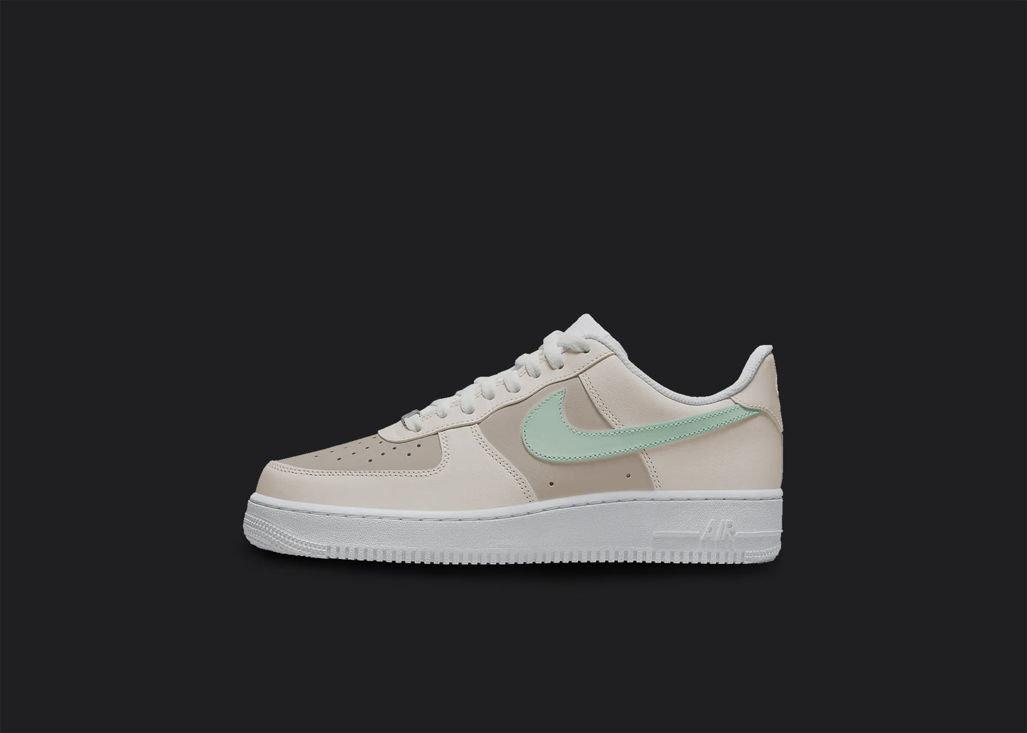 The image is of a Custom Nike Air force 1 sneaker on a blank black background. The white custom sneaker has a creme tone and a mint colored nike logo.