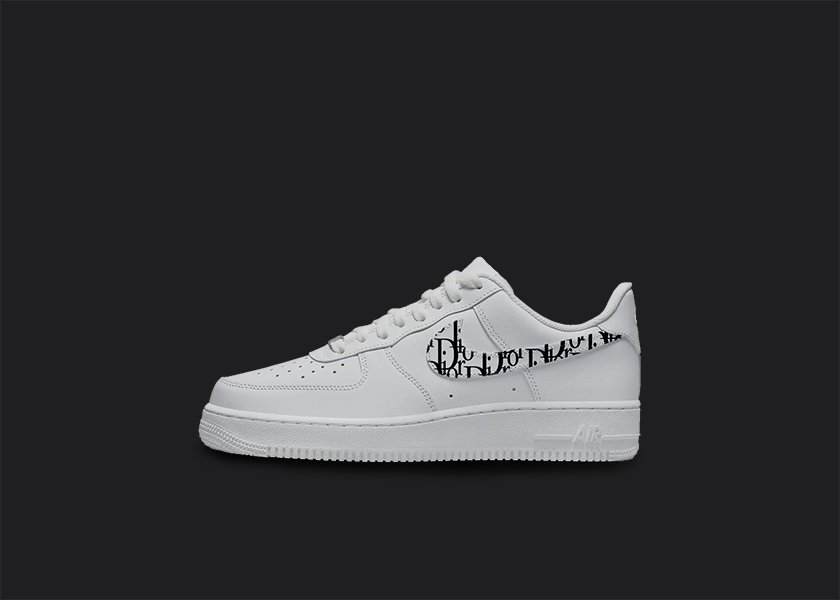 The image is featuring a Custom Dior pattern Air force 1 sneakers on a blank black background. The white nike sneaker has a dior pattern design on the side of the nike logo. 