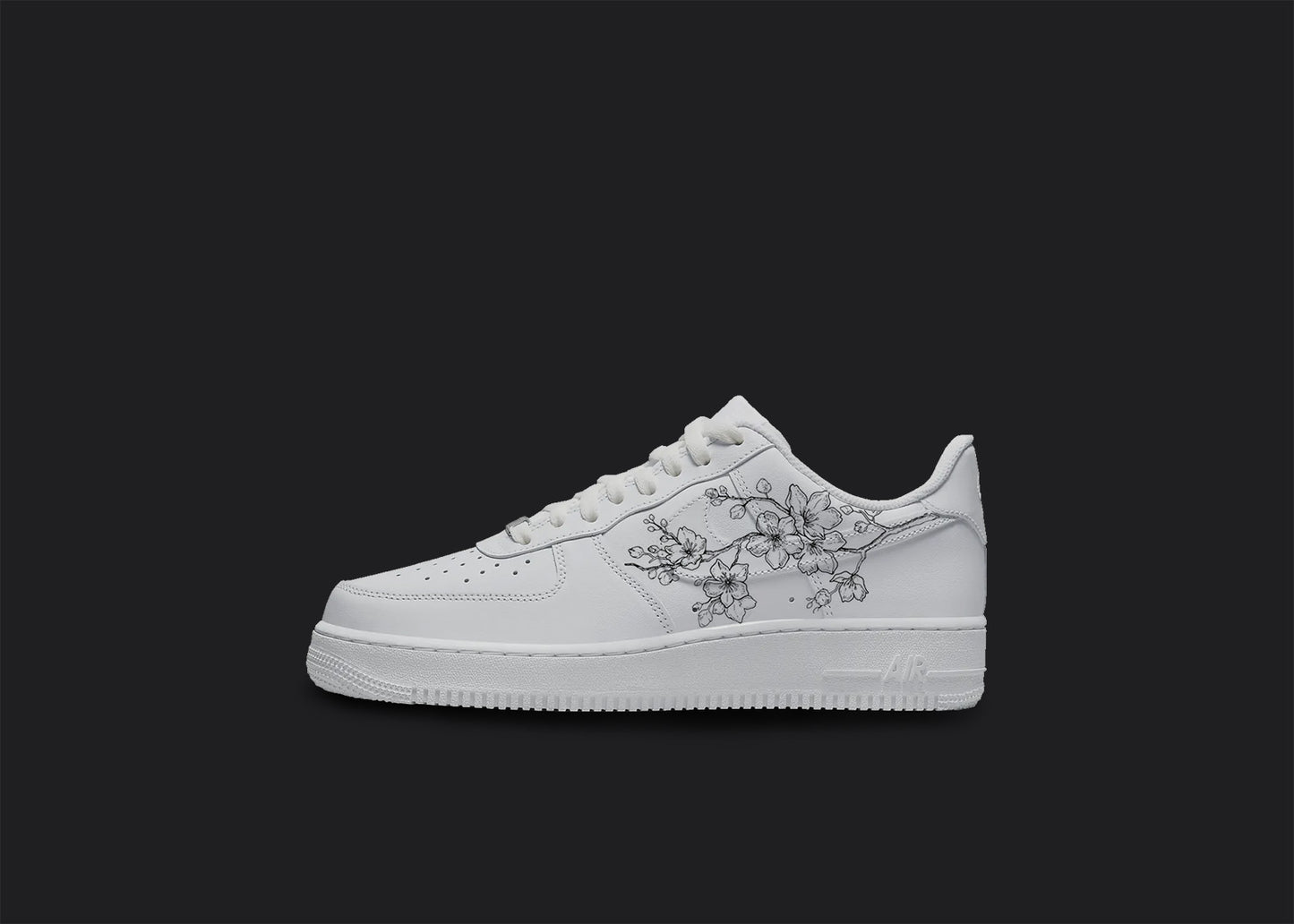 The image is of a Custom Nike Air force 1 sneaker on a blank black background. The white custom sneaker has a floral design on the nike logo.
