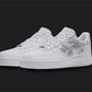 The image is of a Custom Nike Air force 1 sneaker pair on a blank black background. The white custom sneakers have a floral on the nike logo.