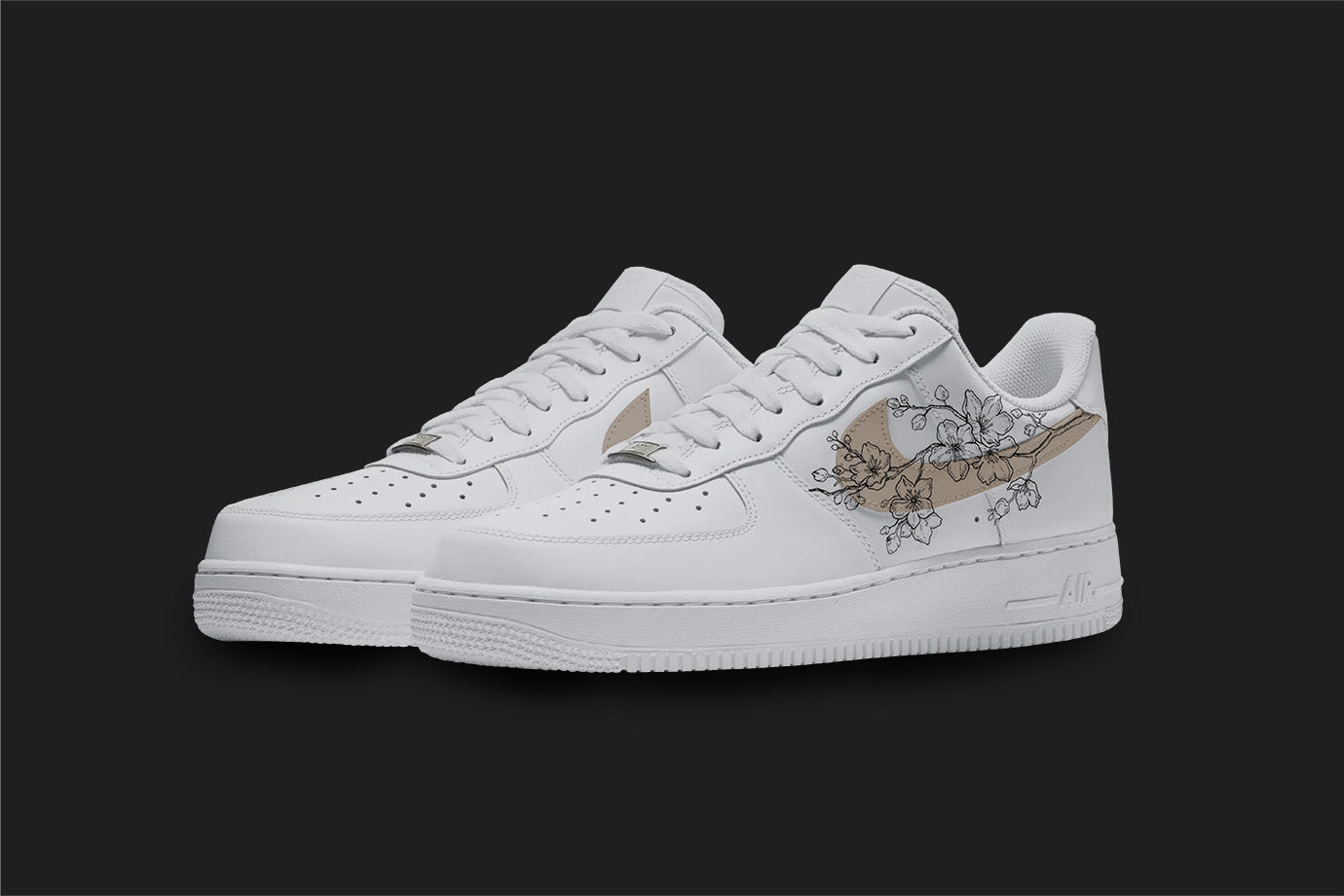 The image is of a Custom Nike Air force 1 sneaker pair on a blank black background. The white custom sneakers have a beige nike logo with floral illustrations on the sides.