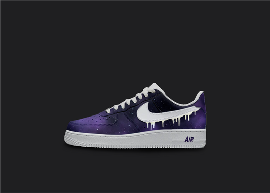 Custom Nike air force 1s are displayed on a dark blank background. The sneakers feature a  custom galaxy fade design with white star splatters all over the sneakers. The Nike logo is painted in white with a dripping designs. 