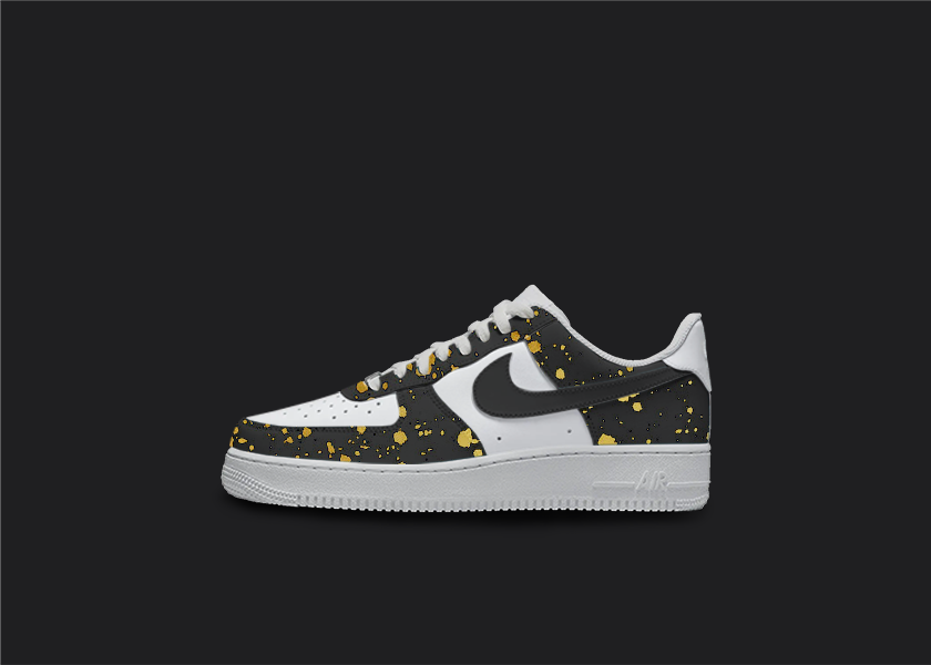 Custom Nike air force 1s are displayed on a dark blank background. The sneakers feature a black custom design with golden splatter all over the sneakers.