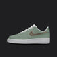 The image is of a Custom Nike Air force 1 sneaker on a blank black background. The white custom sneaker has a Green and brown colorway design.