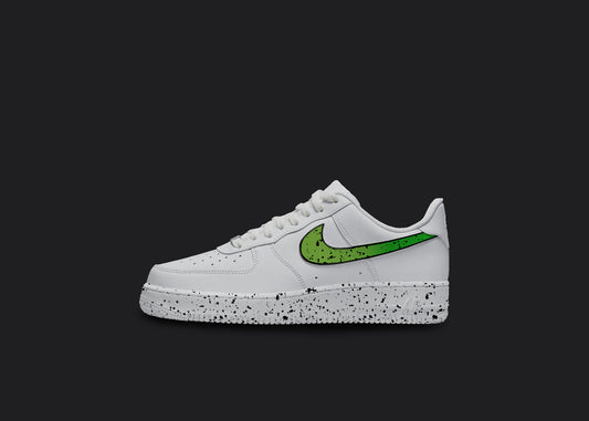 The image is of a Custom Nike Air force 1 sneaker on a blank black background. The white custom nike sneaker has a green splatter covering the sole and the nike logo. 