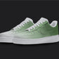 The image is of a Custom Nike Air force 1 sneaker pair on a blank black background. The white custom sneakers have a green fade covering the white nike sneakers.