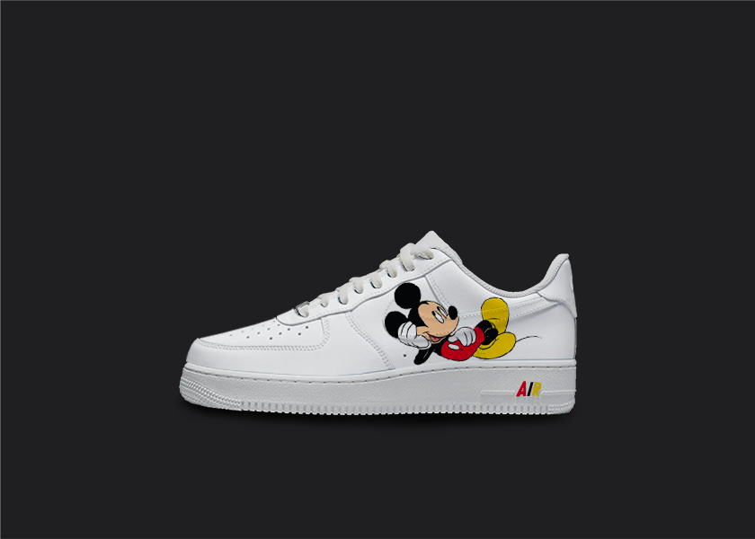 Custom Mickey Mouse inspired Nike Air Force 1 sneakers with Mickey laying on his back on the sole of the sneaker, on a black background with a white Nike swoosh, perfect for Disney fans looking to add a touch of nostalgia and Disney culture to their shoe collection.