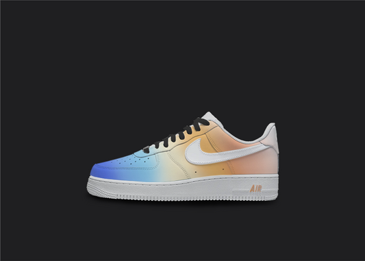 Stand out with these custom Ombre Fade Nike Air Force 1s featuring a black background and a blend of blue, yellow, and orange. A must-have for any sneaker enthusiast.