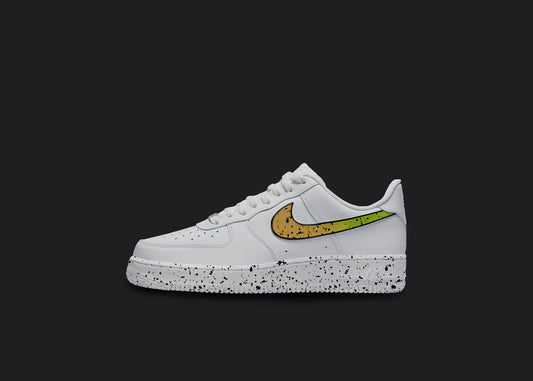 The image is of a Custom Nike Air force 1 sneaker on a blank black background. The white custom nike sneaker has a orange splatter covering the sole and the nike logo.  