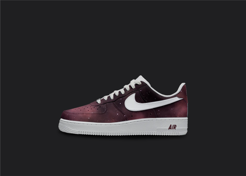 Custom Nike air force 1s are displayed on a dark blank background. The sneakers feature a  custom red galaxy fade design with white star splatters all over the sneakers. The Nike logo is painted in white.