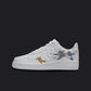  The image is of a Custom Nike Air force 1 shoes on a blank black background. The white custom nike shoe has a tom and jerry design on the side.  