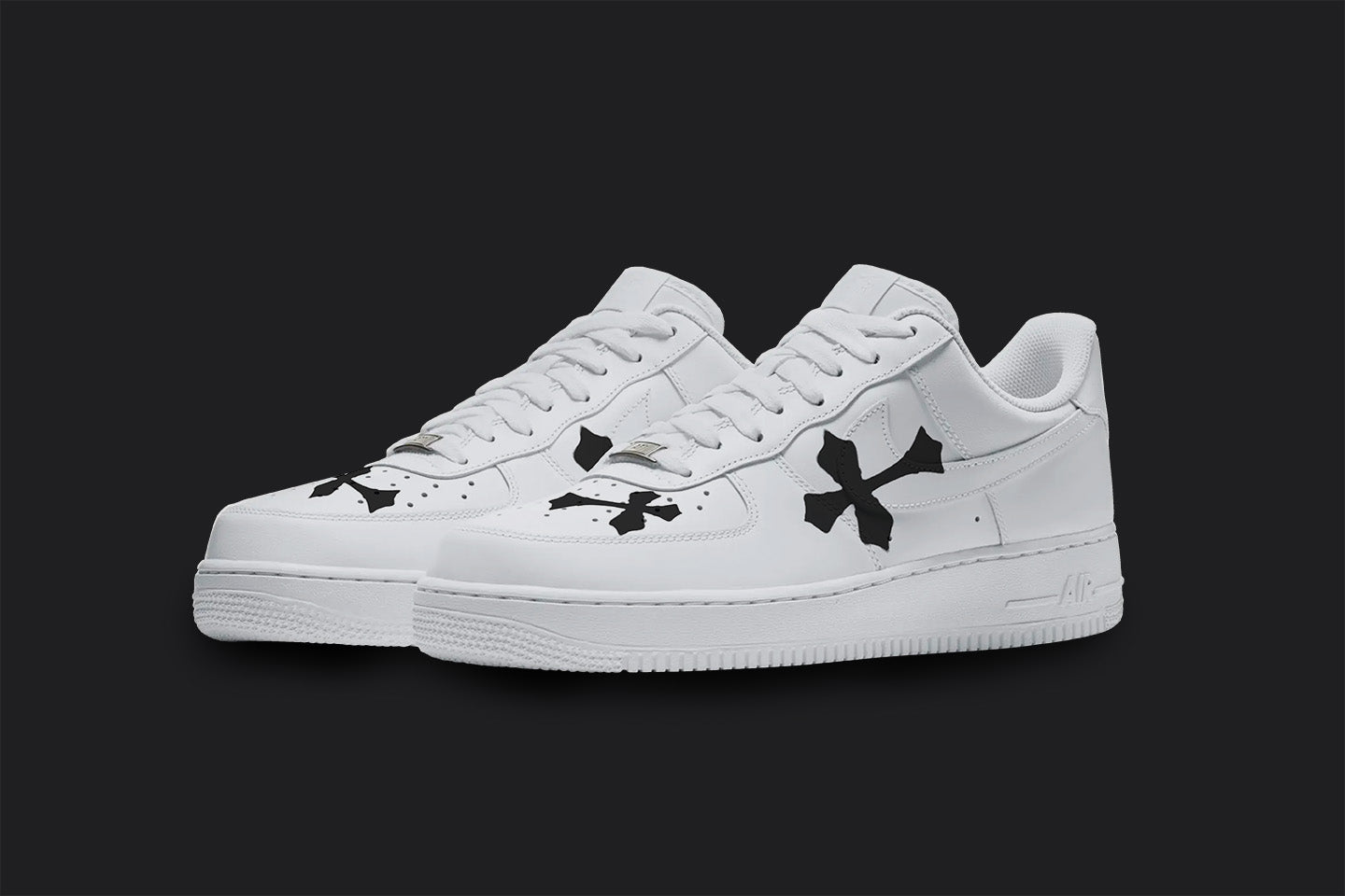 The image is of a Custom Nike Air force 1 sneakers on a blank black background. The custom sneaker pair has black crosses on different part of the white sneakers