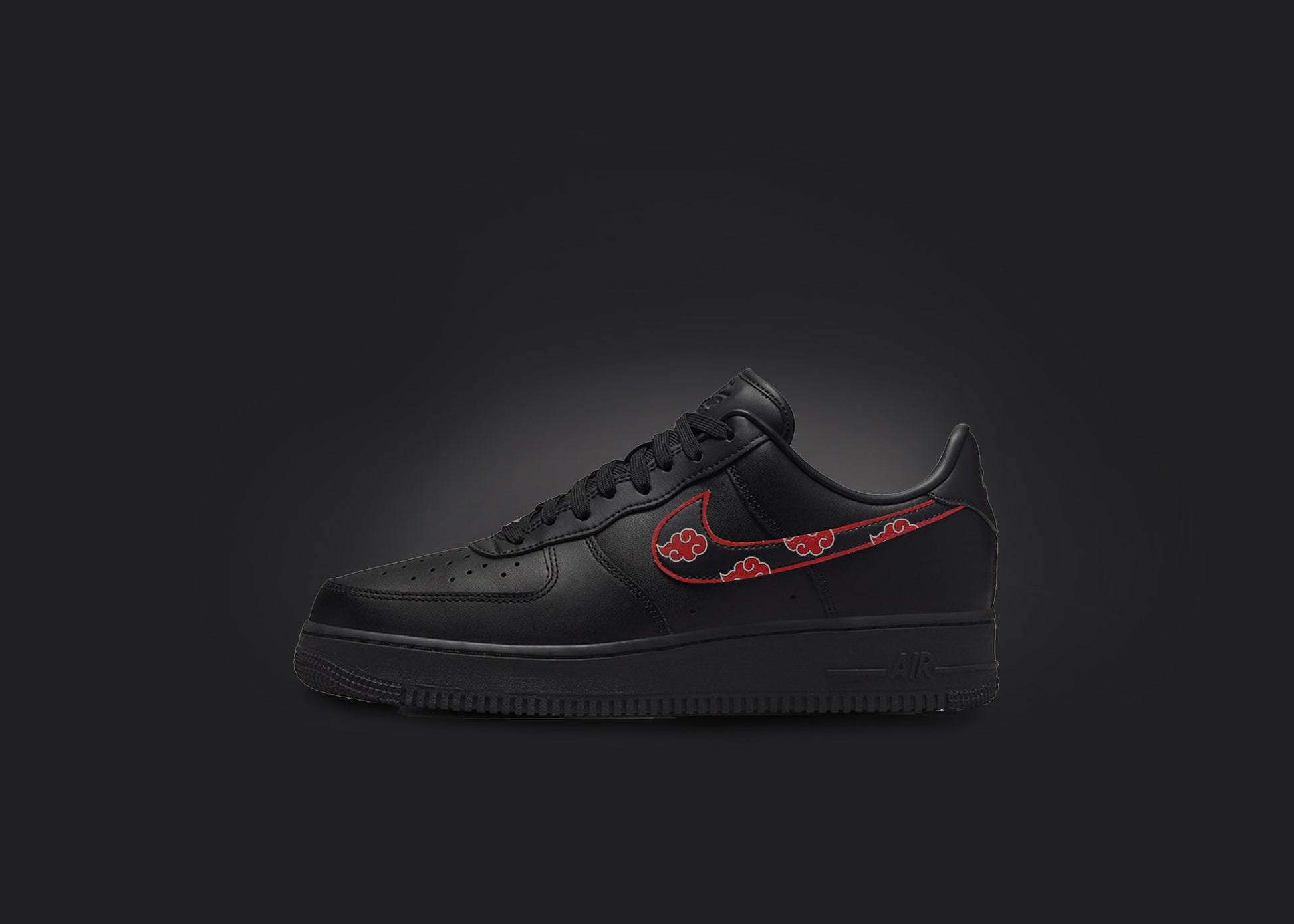 The image is featuring a custom black Air force 1 sneaker on a blank black background. The black nike sneaker has a custom itachi clouds design on the nike logo. 