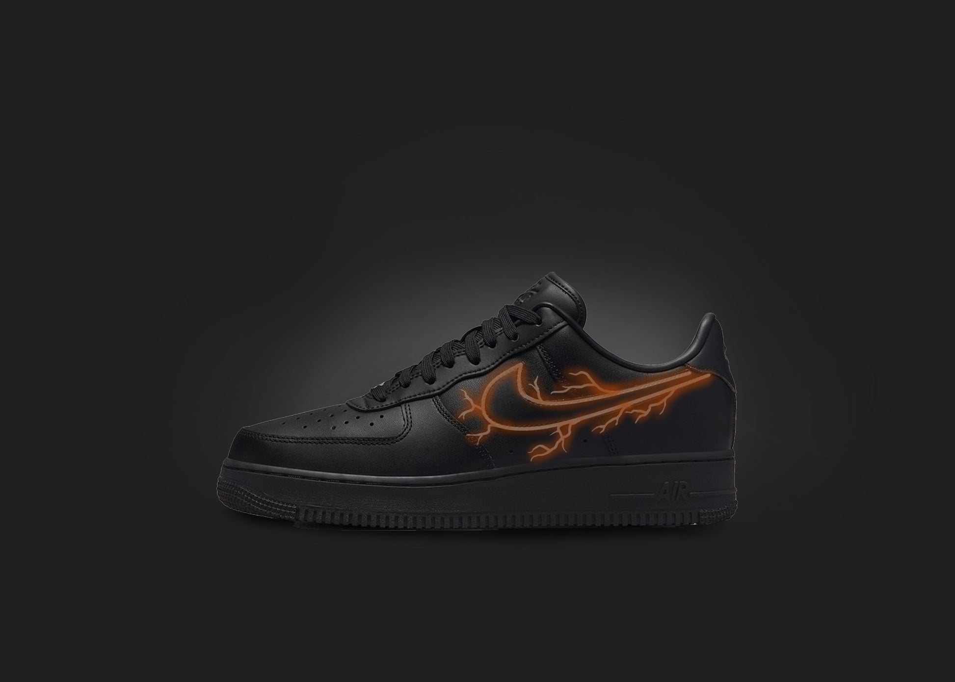 The image is featuring a custom black Air force 1 sneaker on a blank black background. The black nike sneaker has a orange lightning design on the nike logo. 