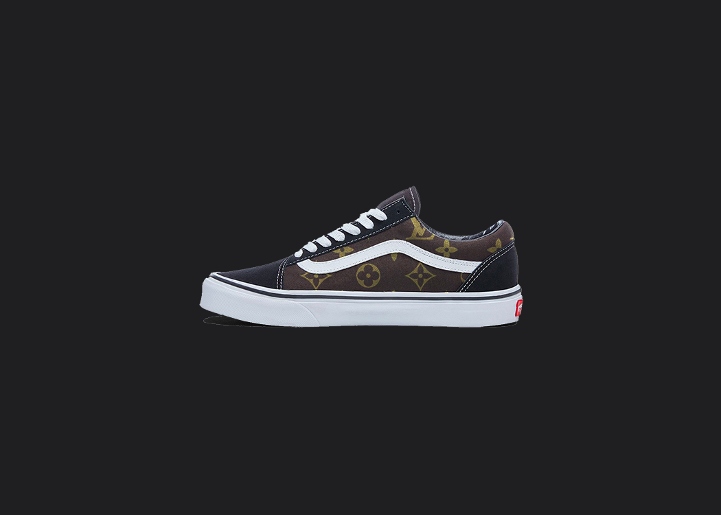 The image is featuring a custom hand painted vans shoes on a blank black background. The vans old skools sneaker has a brown custom vans louis vuitton design on the side of shoes. 