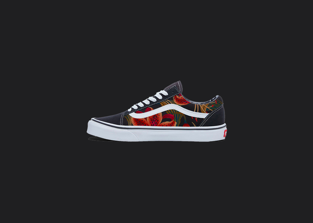 The image is featuring a custom hand painted floral shoes on a blank black background. The vans old skools sneaker has a red floral print design on the side of shoes. 