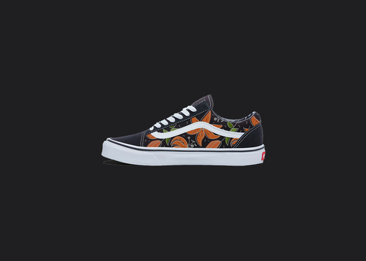 The image is featuring a custom hand painted floral shoes on a blank black background. The vans old skools sneaker has a orange floral print design on the side of shoes. 