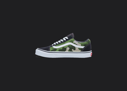 The image is featuring a custom hand painted vans shoes on a blank black background. The vans old skools sneaker has a custom green camo design on the side of shoes. 