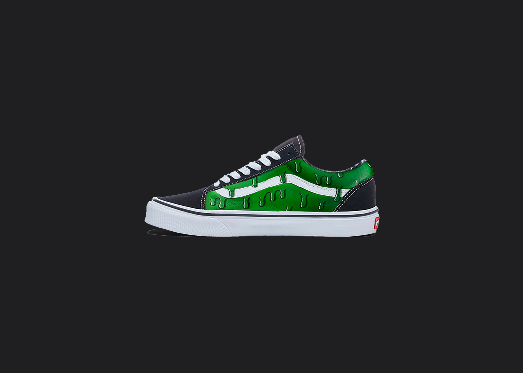 The image is featuring a custom hand painted dripping vans shoes on a blank black background. The vans old skools sneaker has a green drip shoes design on the side of shoes. 