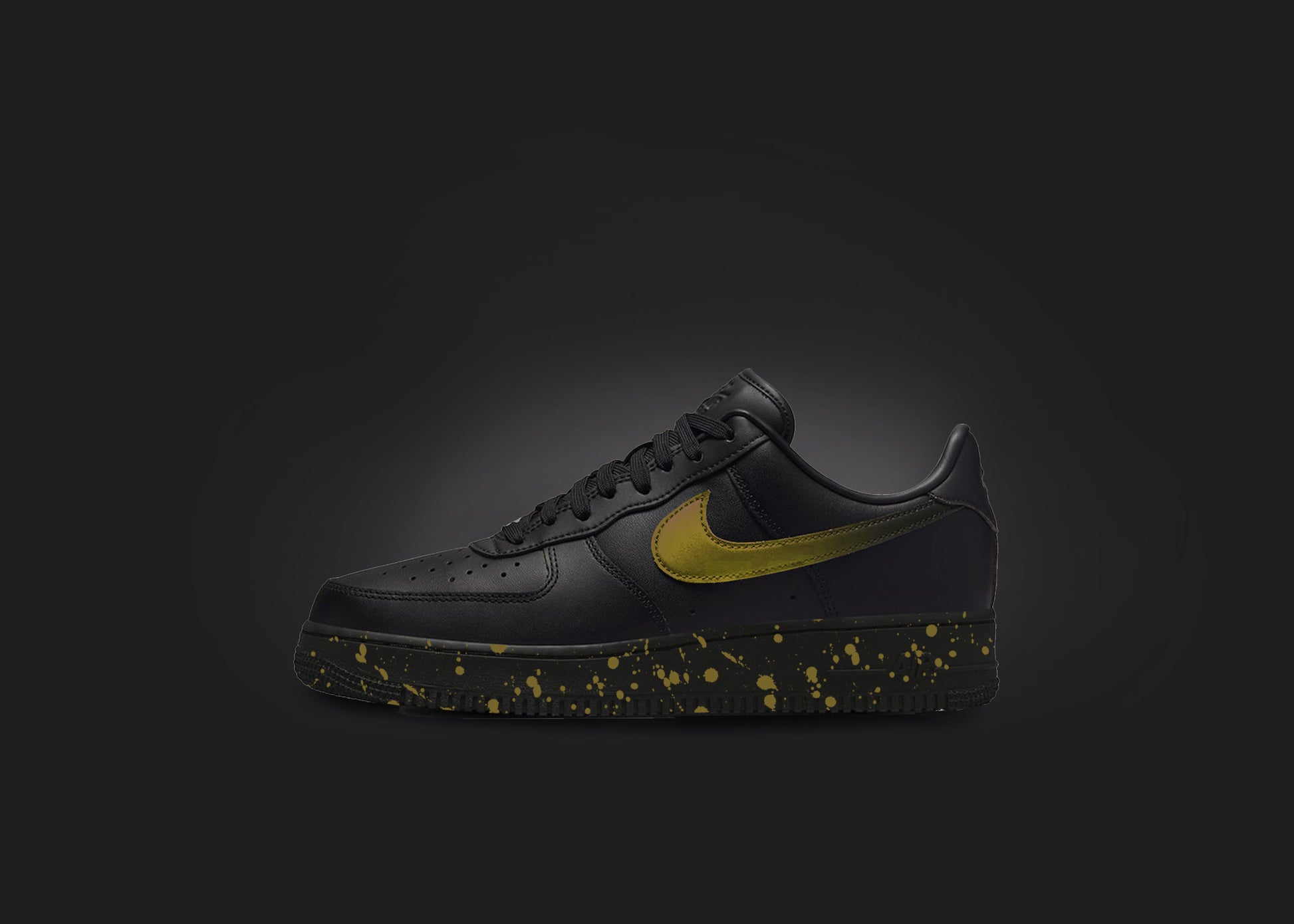 The image is featuring a custom black Air force 1 sneaker on a blank black background. The black nike sneaker has a yellow paint splatter design on the sole and a yellow fade on the nike logo. 